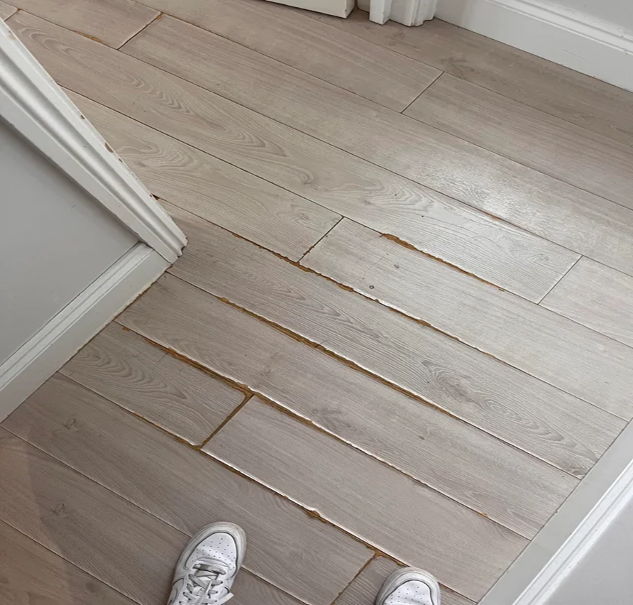 11 Costly Flooring Mistakes (And How to Avoid Them) 2 Flooring mistakes to avoid, Common flooring mistakes, How to choose the right flooring, SPC hybrid flooring, Flooring tips for homeowners, Waterproof flooring options, Office flooring solutions, Avoid flooring damage, Subfloor preparation, Flooring warranties explained, Climate impact on flooring, Moisture-resistant flooring person standing on ruined hardwood floor